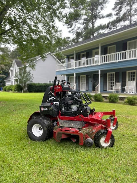 Mower parked on a lawn after finishing service